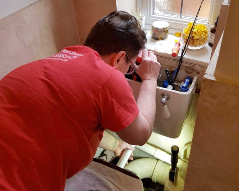 Sally King working on toilet cistern