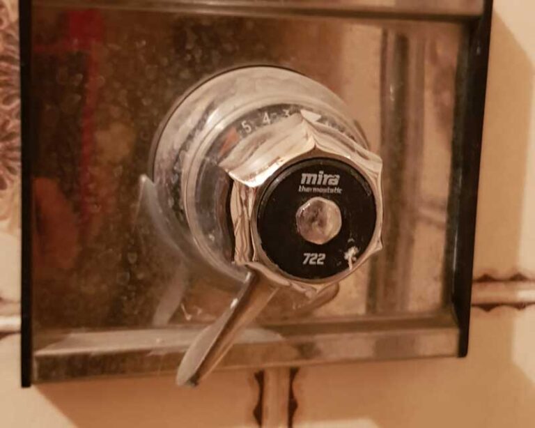 Replace concealed shower valve with exposed shower valve with a bit of tile work